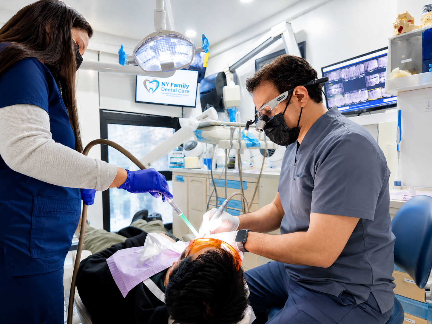 Dr. providing dental treatment at NY Family Dental Care
